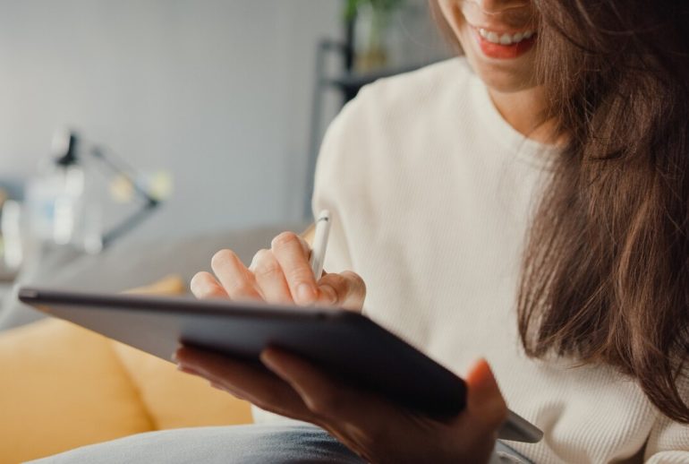 close-up-freelance-asian-lady-casual-wear-using-tablet-online-learn-living-room-house-work-from-home-remotely-work_7861-3276